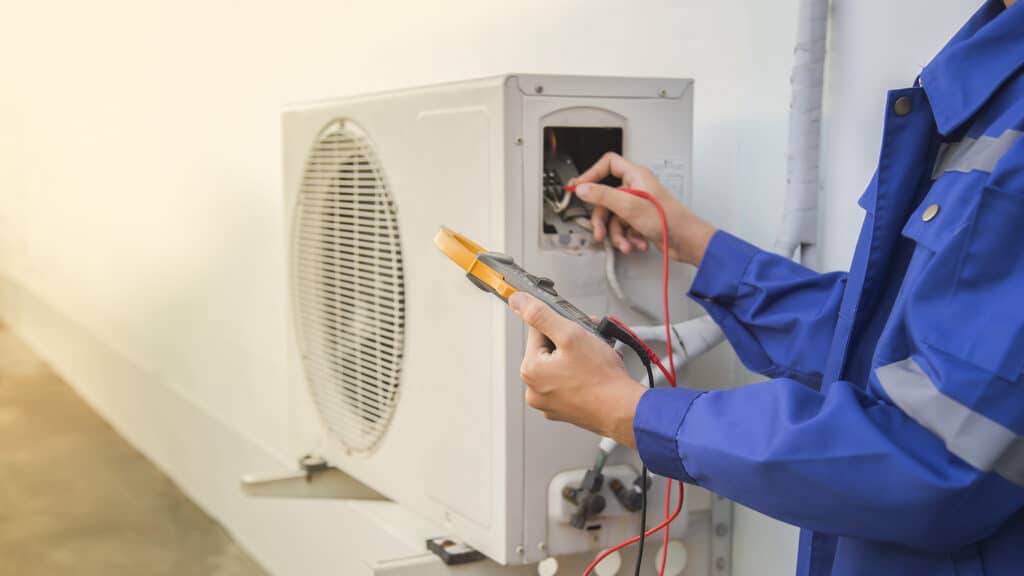 Technician checking the operation of the air conditioner