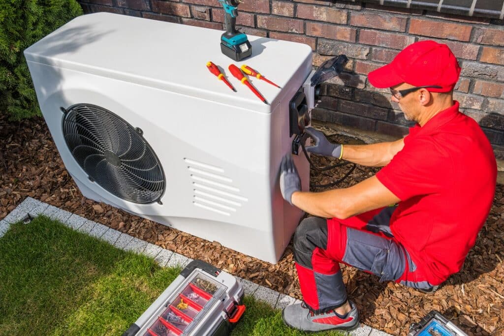 Technician Repairing Modern Heat Pump