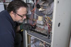 Technician looking over a gas furnace